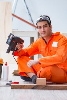 Contractor working on laminate wooden floor