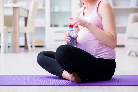 Pregnant woman exercising in anticipation of child birth