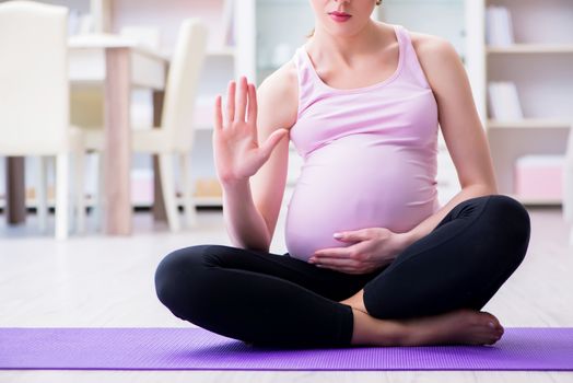 Pregnant woman exercising in anticipation of child birth