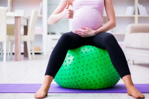 Pregnant woman exercising in anticipation of child birth