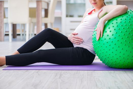 Pregnant woman exercising in anticipation of child birth