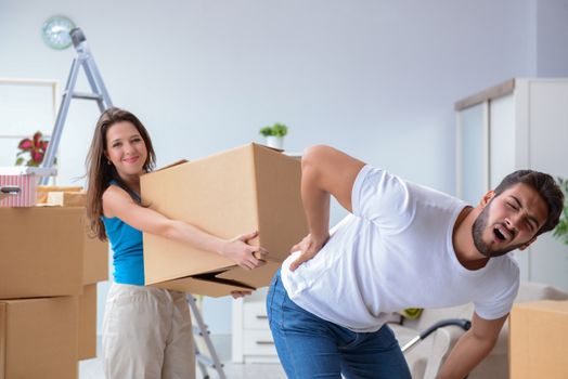 Young family unpacking at new house with boxes