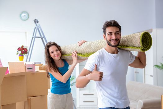 Young family unpacking at new house with boxes