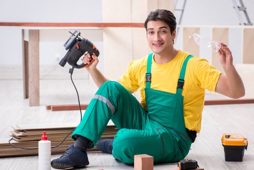 Contractor working on laminate wooden floor