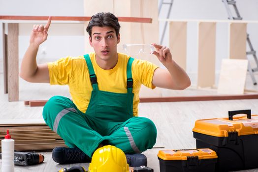 Contractor working on laminate wooden floor 