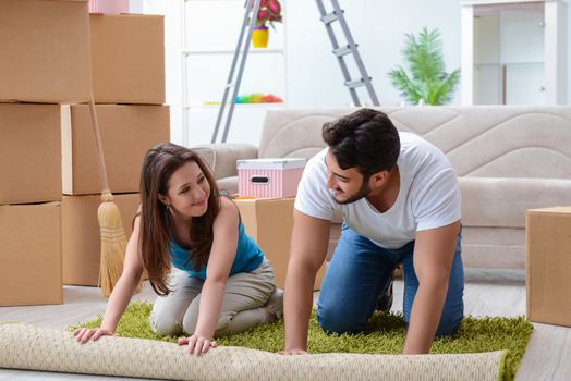 Young family unpacking at new house with boxes