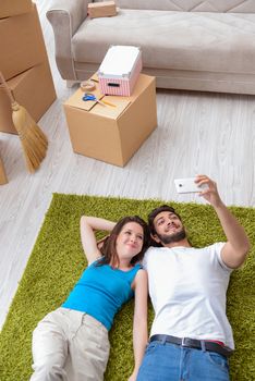 Young family unpacking at new house with boxes