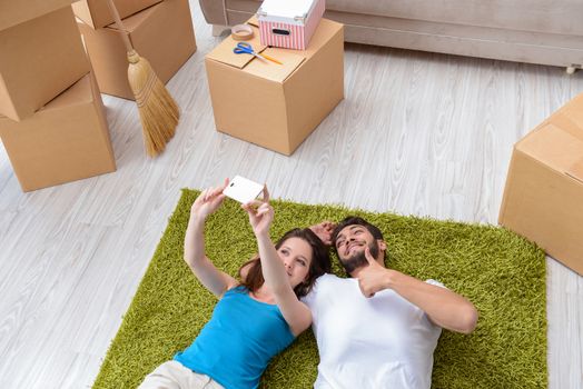 Young family unpacking at new house with boxes