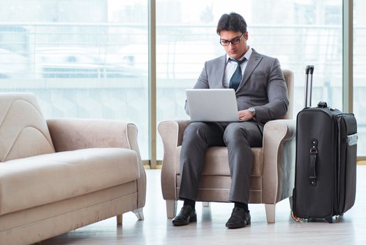 Young businessman in airport business lounge waiting for flight