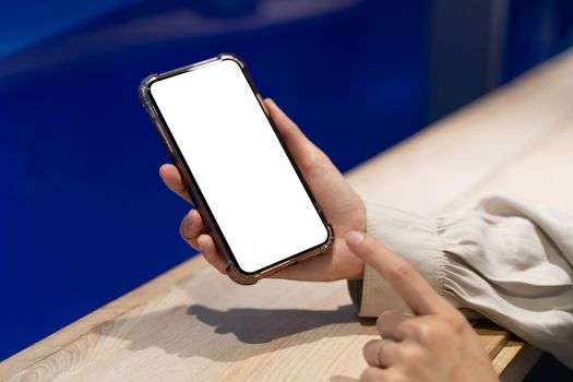 Woman hand showing white screen mobile mockup.