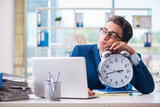 Businessman with giant clock failing to meet deadlines and missing them