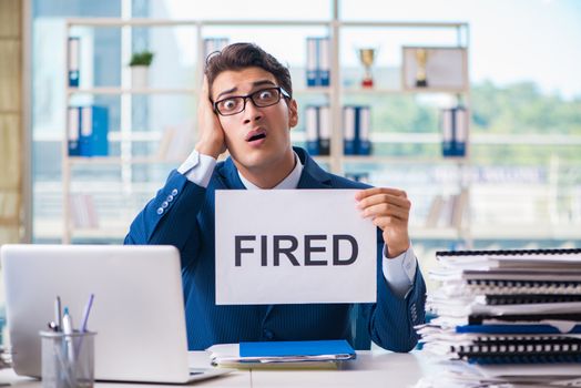 Businessman with message in the office at desk