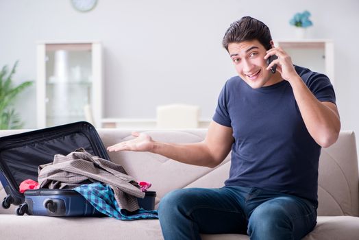 Young man preparing packing for summer vacation