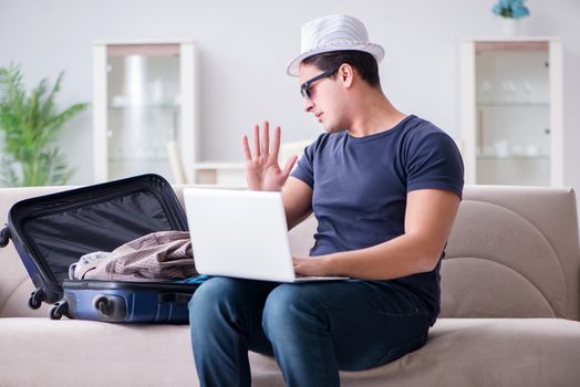 Man booking online his travel flight and hotel