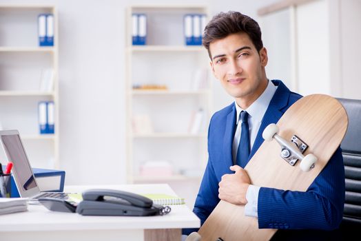 Young businessman with skate in office in sports concept