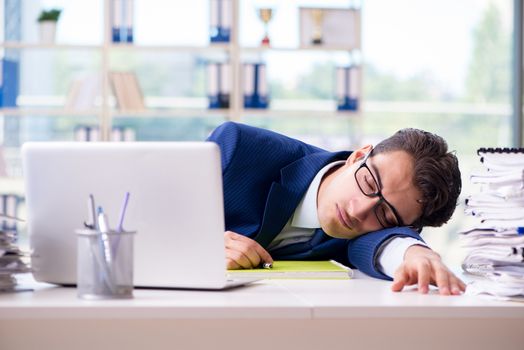 Tired businessman exhausted after hard work and excessive workload