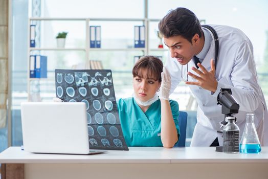 Two doctors discussing x-ray MRI image in hospital