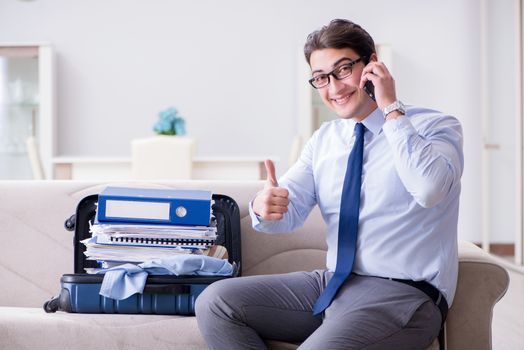 Businessman preparing packing for business trip