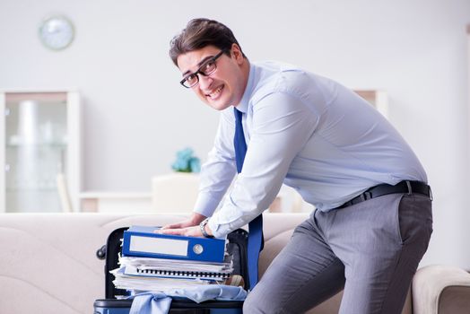 Businessman preparing packing for business trip
