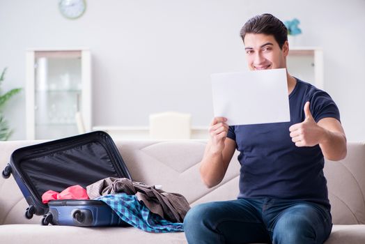 Young man preparing packing for summer vacation