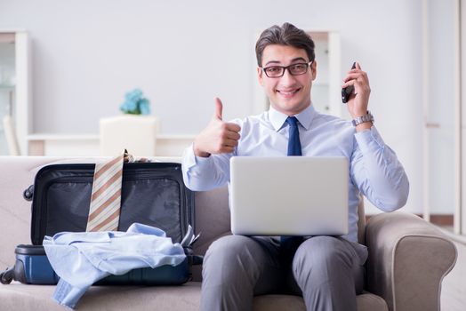 Businessman preparing packing for business trip