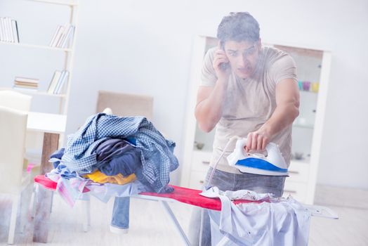 Inattentive husband burning clothing while ironing