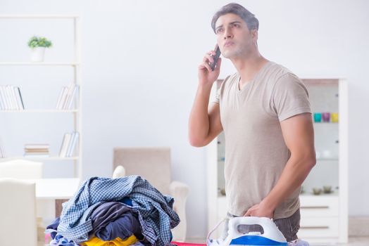 Inattentive husband burning clothing while ironing