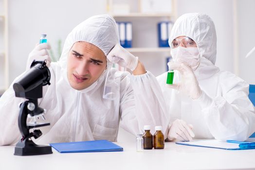 Two chemists working in the lab