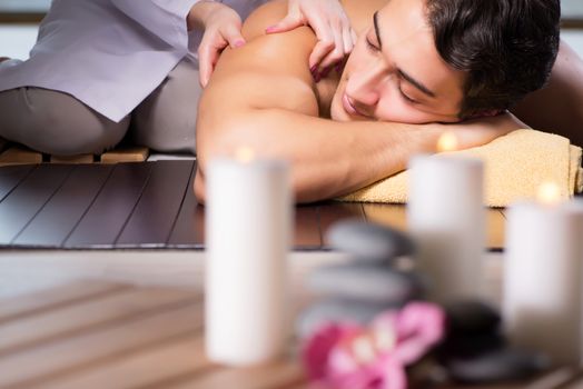 Young handsome man during spa procedure