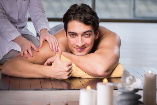 Young handsome man during spa procedure