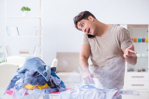 Inattentive husband burning clothing while ironing