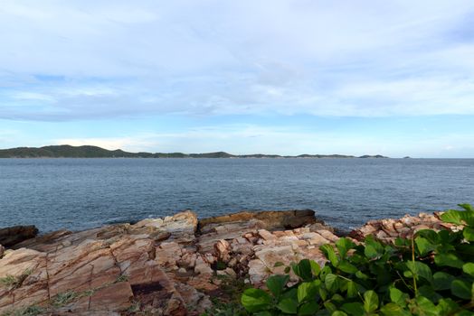 Coastal sea pictures With creepers and cracked rocks in the foreground And there are islands against the sky in the background. Eastern tourist attractions of Thailand.