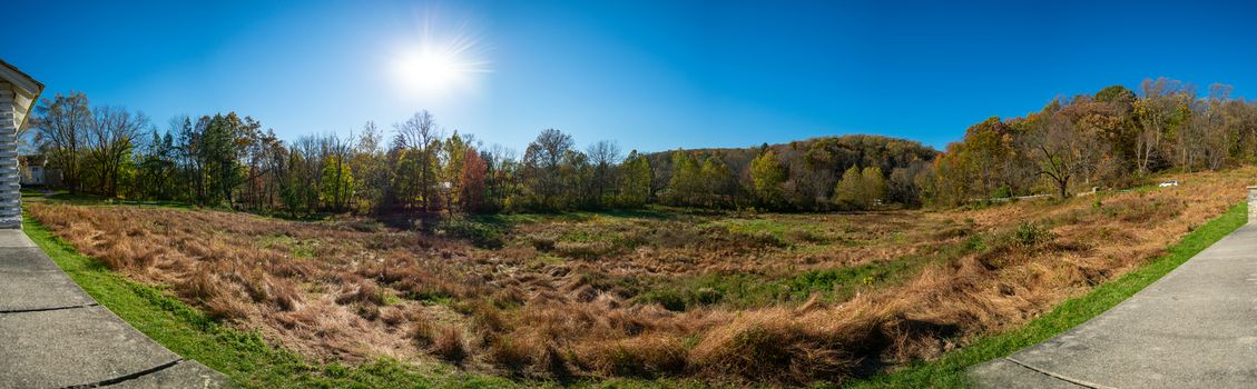 A Panoramic Shot of an Open Field on a Clear Autumn Day With the sun Behind Trees at Valley Forge
