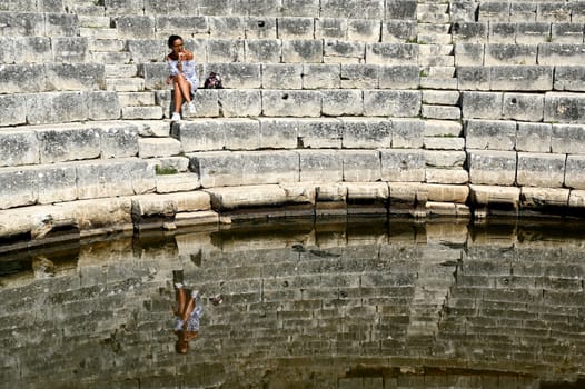 Young girl exploring an ruins of ancient city of Butrint.Olive-shaded archaeological site home to the Greek, Roman & medieval remains of the city of Butrint.