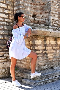 Young girl exploring an ruins of ancient city of Butrint.Olive-shaded archaeological site home to the Greek, Roman & medieval remains of the city of Butrint.