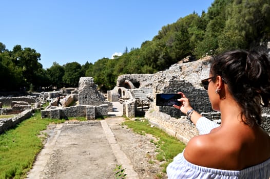 Young girl exploring an ruins of ancient city of Butrint.Olive-shaded archaeological site home to the Greek, Roman & medieval remains of the city of Butrint.