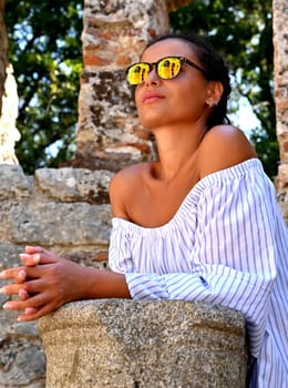 Young girl exploring an ruins of ancient city of Butrint.Olive-shaded archaeological site home to the Greek, Roman & medieval remains of the city of Butrint.