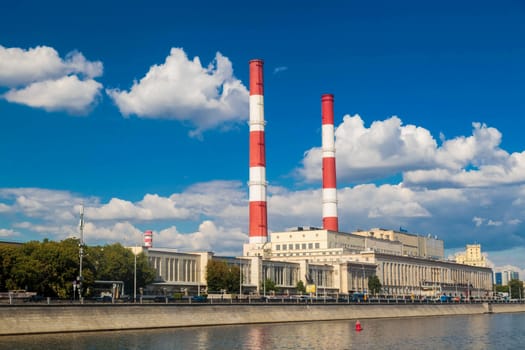 MOSCOW, RUSSIA - AUGUST 21, 2020:  Building with two pipes view from the moscow river to the embankment.