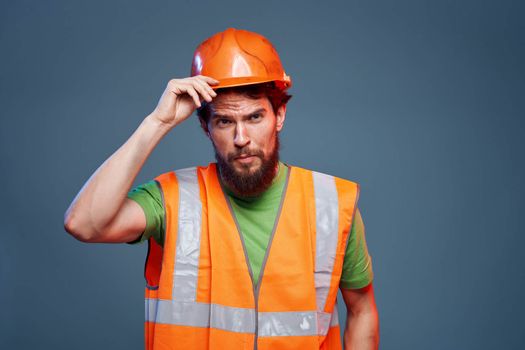 Man in working uniform to professionals construction lifestyle blue background. High quality photo