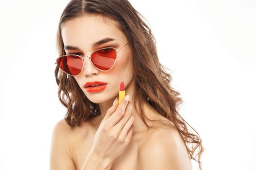 Fashionable brunette in sunglasses with makeup lipstick model. High quality photo