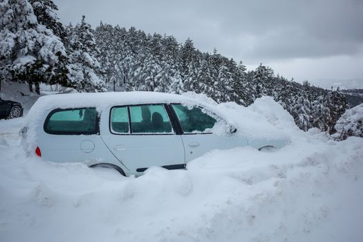 Car stuck in deep snow on mountain road - winter traffic problem stock image