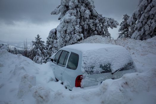 Car stuck in deep snow on mountain road - winter traffic problem stock image