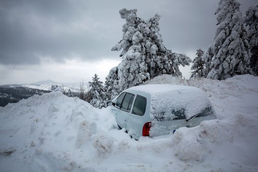 Car stuck in deep snow on mountain road - winter traffic problem stock image