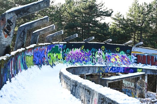 Abandoned bob trail on Trebevic Mountain near Sarajevo, decorated with graffiti