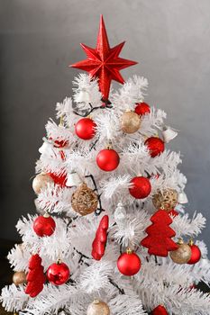 White Christmas tree, with red decoration and christmas light