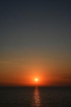 Red sunset over the sea, rich in dark clouds, rays of light, captured near Saranda, Albania