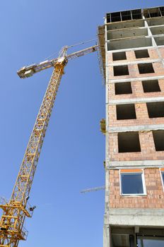 Apartment building constructions, with big crane in motion