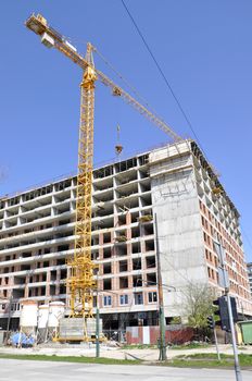 Apartment building constructions, with big crane in motion