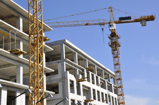 Apartment building constructions, with big crane in motion