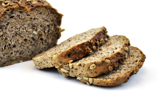 Whole wheat bread with seeds, isolated on white background and slices